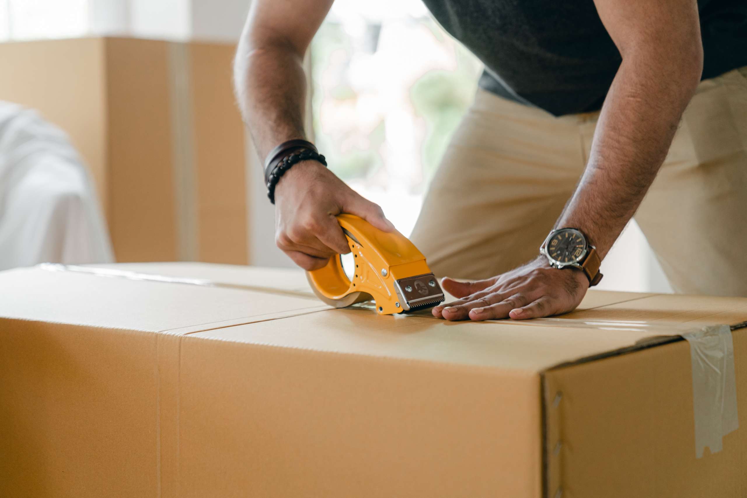 crop-faceless-man-preparing-box-for-shipping-4246124